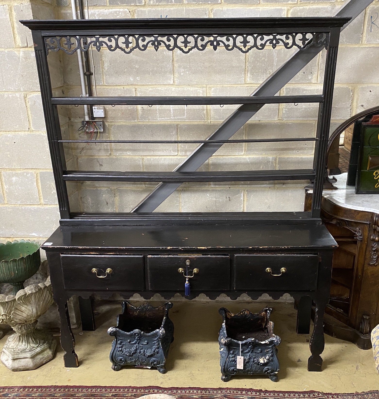 An 18th century painted pine provincial dresser, with silhouette leg and open fretwork rack, length 158cm, depth 41cm, height 195cm